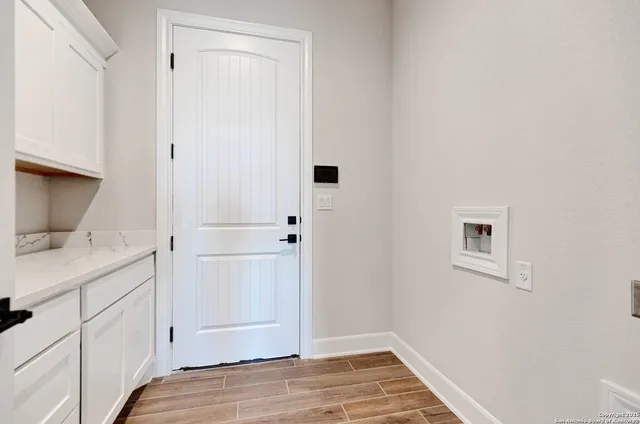 a view of bathroom with a sink cabinet and mirror