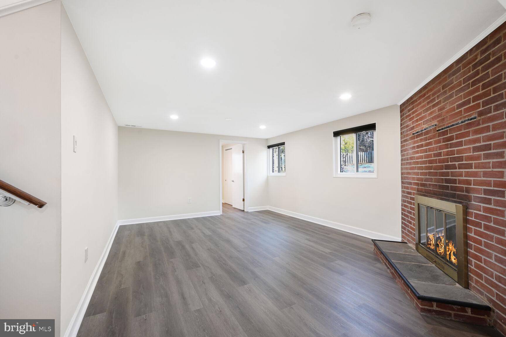 10117 Renfrew Road Silver Spring, MD 20901 - Photo 11 of 15 a view of an empty room with wooden floor and a window