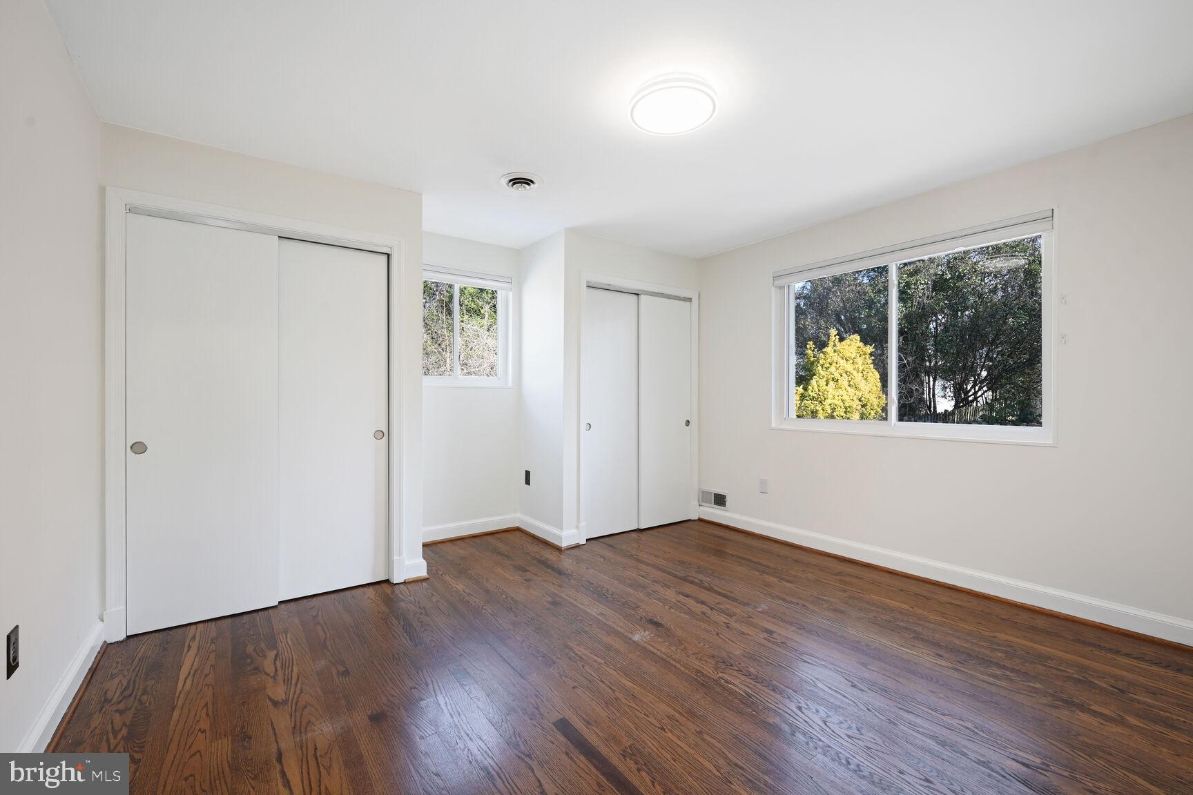 10117 Renfrew Road Silver Spring, MD 20901 - Photo 6 of 15 a view of an empty room with wooden floor and a window