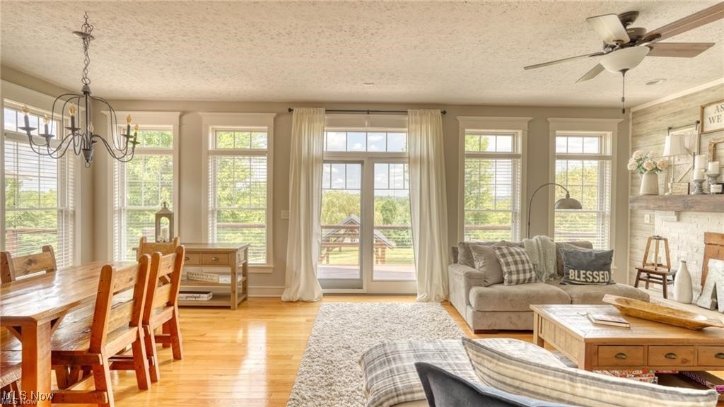 66333 Read Road Cambridge, OH 43725 - Photo 26 of 49 Sunroom / solarium featuring plenty of natural light and ceiling fan with notable chandelier