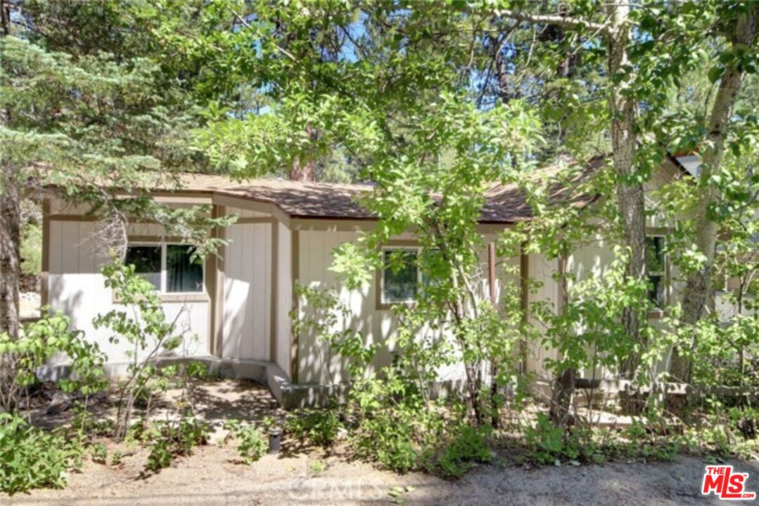39219 Cedar Dell Road Fawnskin, CA 92333 - Photo 1 of 23 a front view of a house with garden