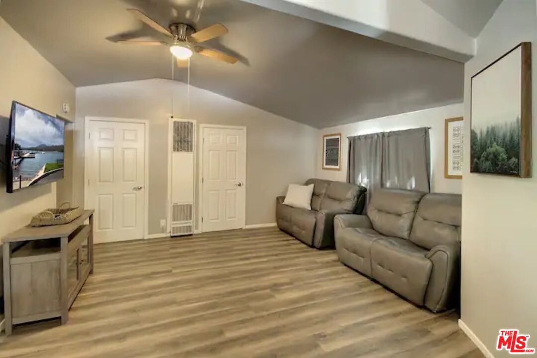 39219 Cedar Dell Road Fawnskin, CA 92333 - Photo 13 of 23 a living room with furniture and a flat screen tv