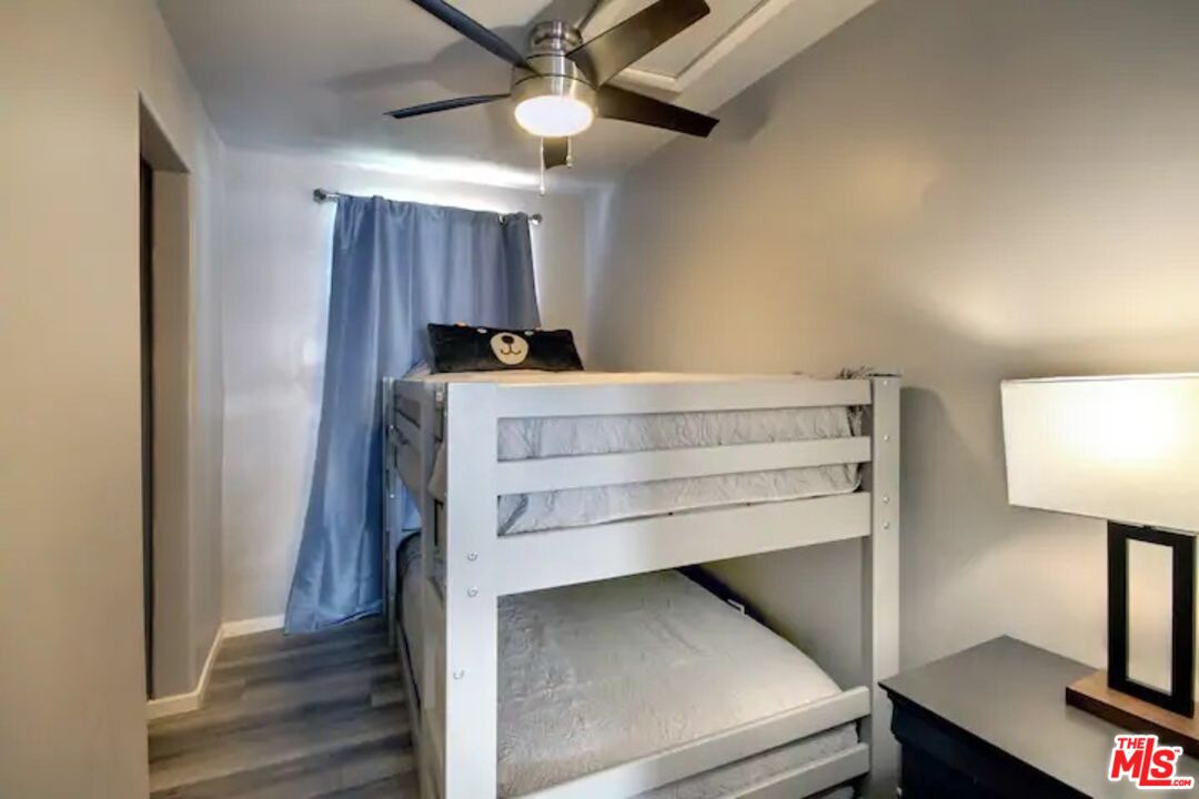 39219 Cedar Dell Road Fawnskin, CA 92333 - Photo 17 of 23 a bedroom with a bed and a lamp on the dresser