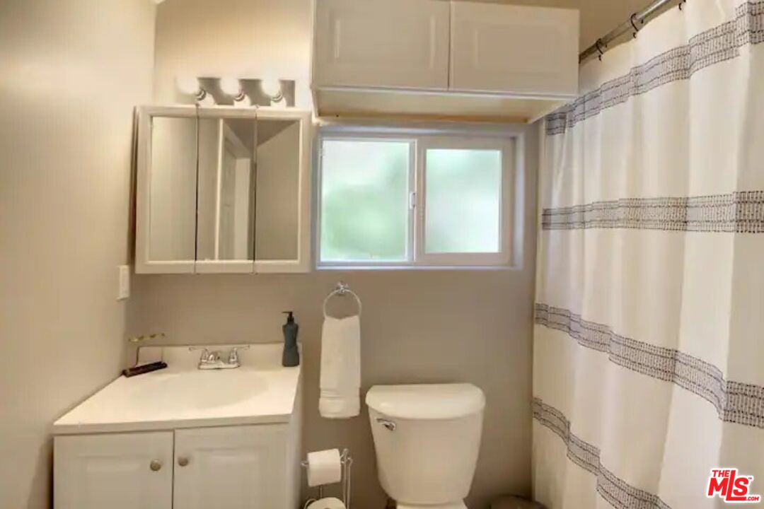 39219 Cedar Dell Road Fawnskin, CA 92333 - Photo 21 of 23 a bathroom with a toilet sink and mirror