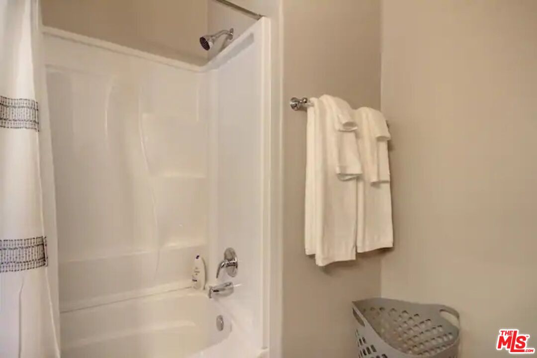 39219 Cedar Dell Road Fawnskin, CA 92333 - Photo 22 of 23 a bathroom with a shower curtain and a sink