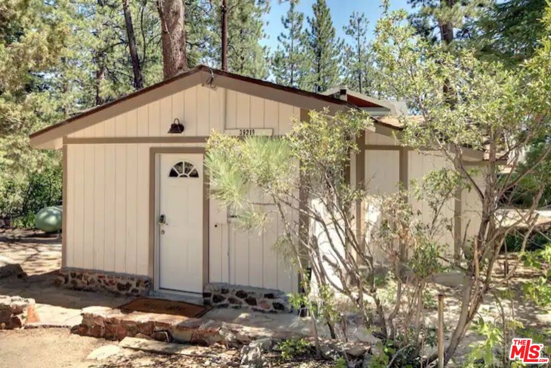 39219 Cedar Dell Road Fawnskin, CA 92333 - Photo 3 of 23 a white house with tree in front of it