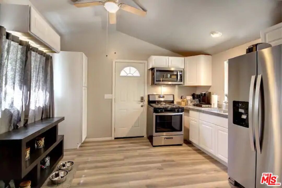 39219 Cedar Dell Road Fawnskin, CA 92333 - Photo 8 of 23 a kitchen with stainless steel appliances granite countertop a refrigerator stove and sink