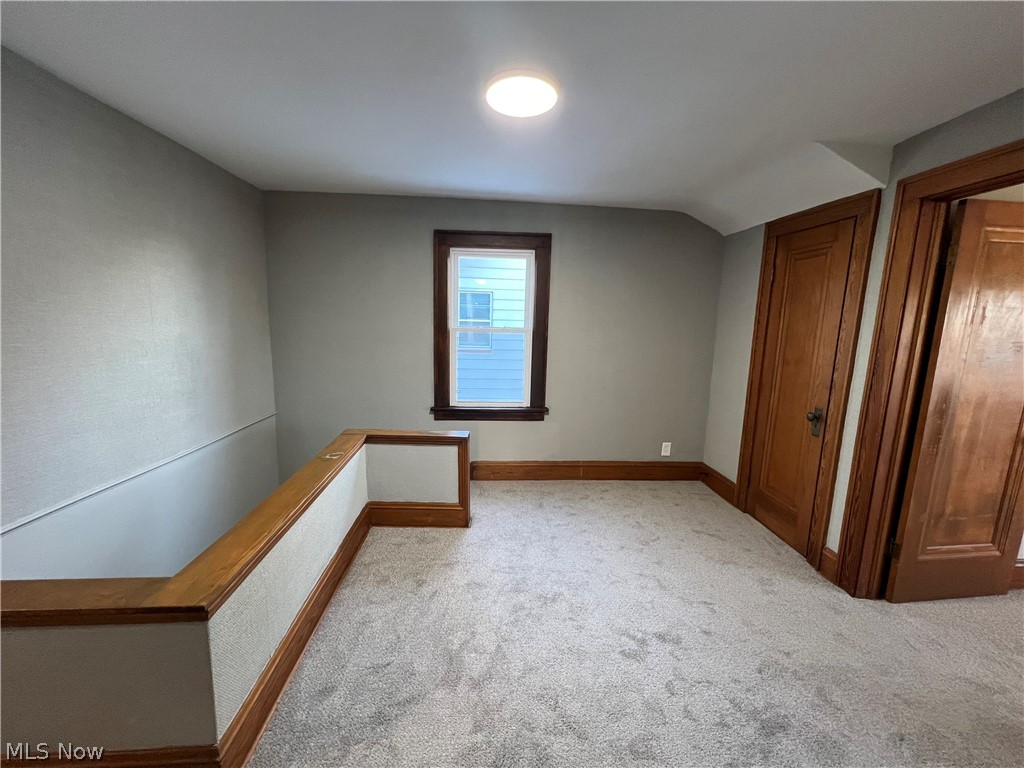 4523 Maplecrest Avenue Parma, OH 44134 - Photo 27 of 31 Carpeted empty room featuring lofted ceiling