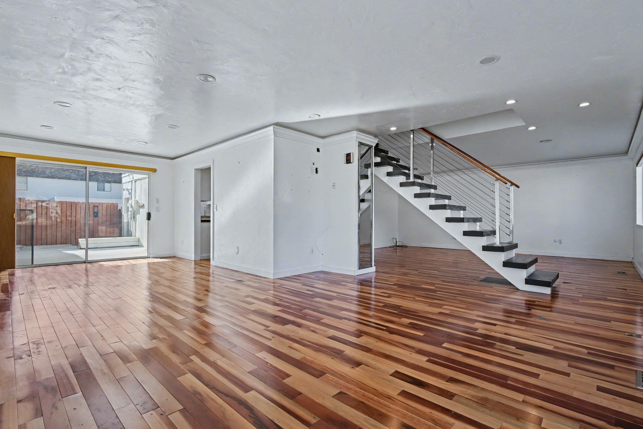 2700 G Road, Unit 12F Grand Junction, CO 81506 - Photo 9 of 24 a view of a livingroom with wooden floor and stairs