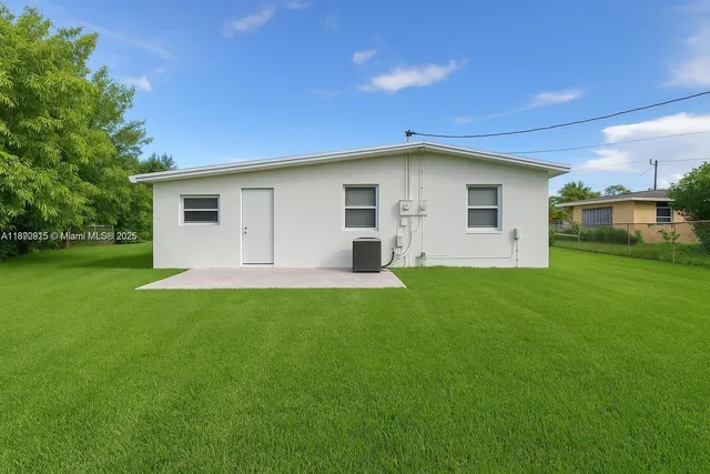 a front view of house with a garden