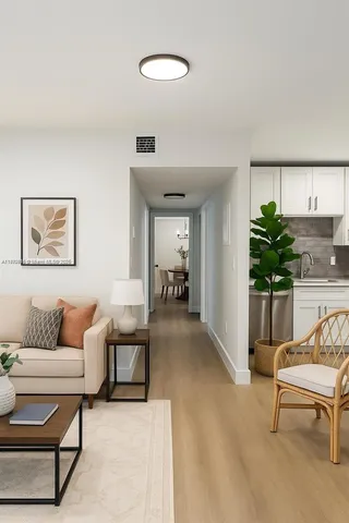 a living room with furniture and a potted plant