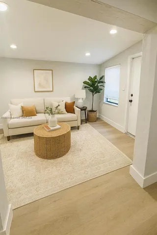 a living room with furniture and a potted plant
