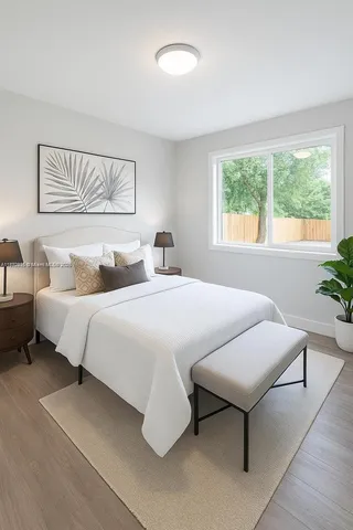 a bedroom with a bed and a night stand