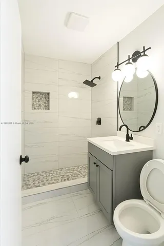 a bathroom with a toilet a sink and mirror