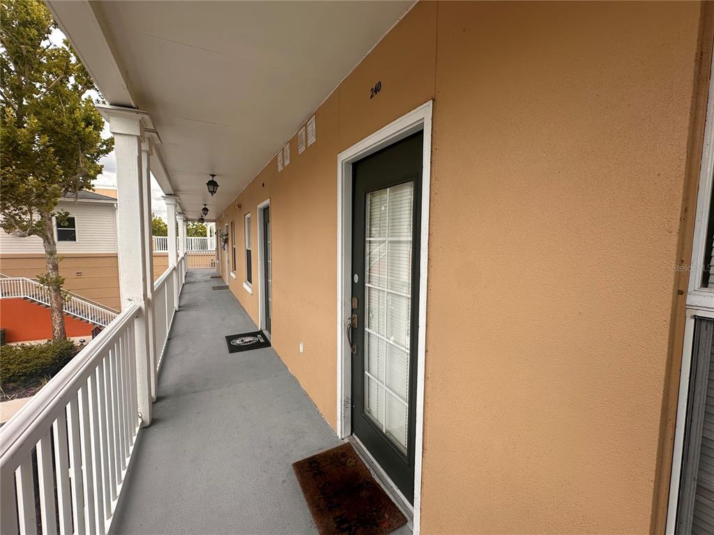 709 Bloom Street, Unit 240 Celebration, FL 34747 - Photo 14 of 17 a view of a hallway with wooden floor and staircase