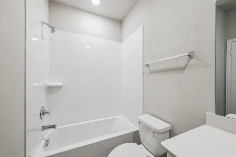 a bathroom with a toilet and a bathtub
