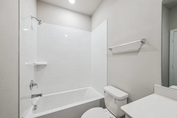 a bathroom with a toilet and a bathtub