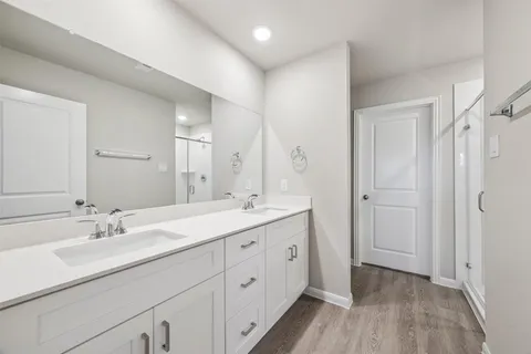 a spacious bathroom with a double vanity sink mirror and