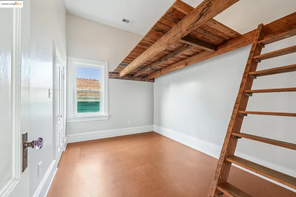 a view of an empty room with stairs