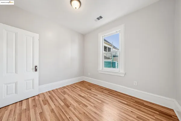 a view of a room with wooden floor and windows