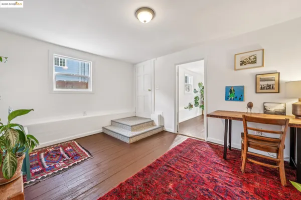 a living room with furniture and a dining table with kitchen view