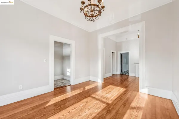 a bedroom with a bed and a wooden floor
