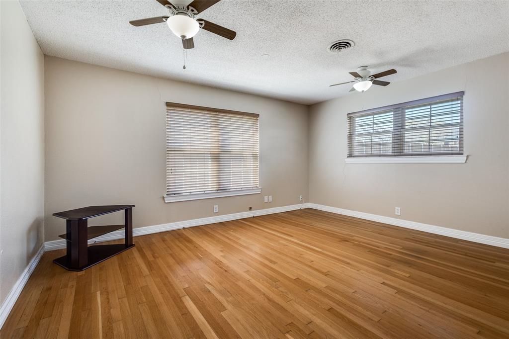 433 Fulton Street Denton, TX 76201 - Photo 17 of 25 wooden floor in an empty room with a window