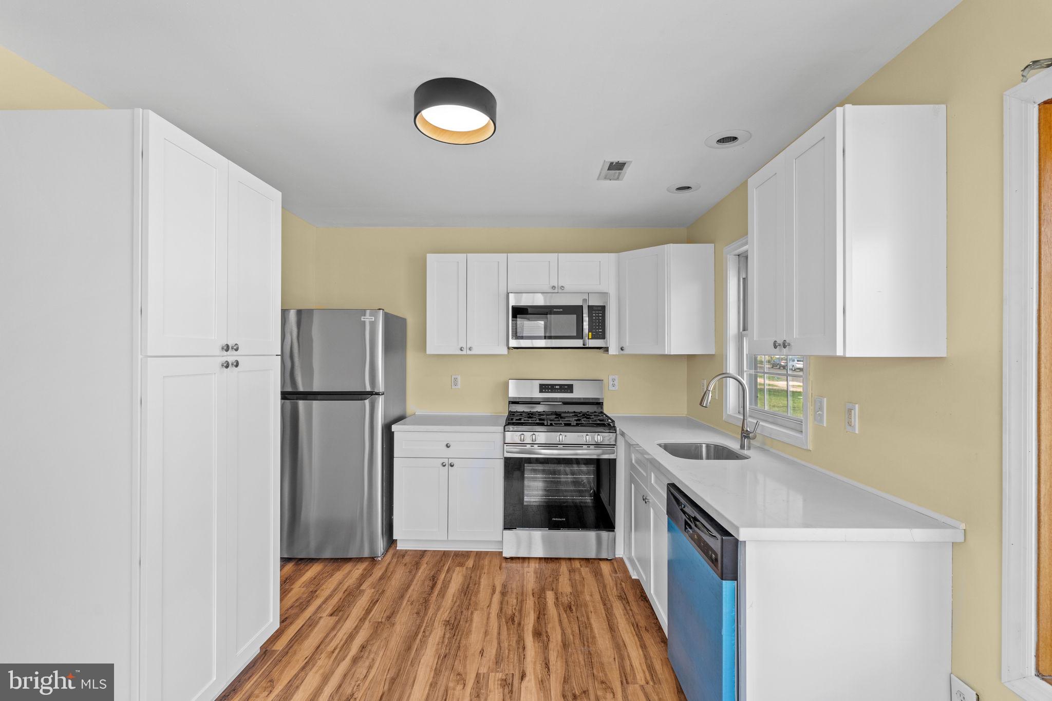 5 Bendix Lane Willingboro, NJ 08046 - Photo 7 of 20 a kitchen with a stove a refrigerator and a sink