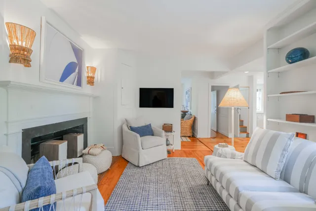 a living room with furniture fireplace and a window