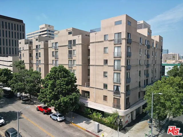 a large building with a clock tower in front of it
