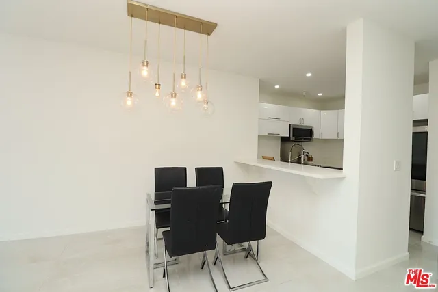 a view of kitchen with dining table and chairs