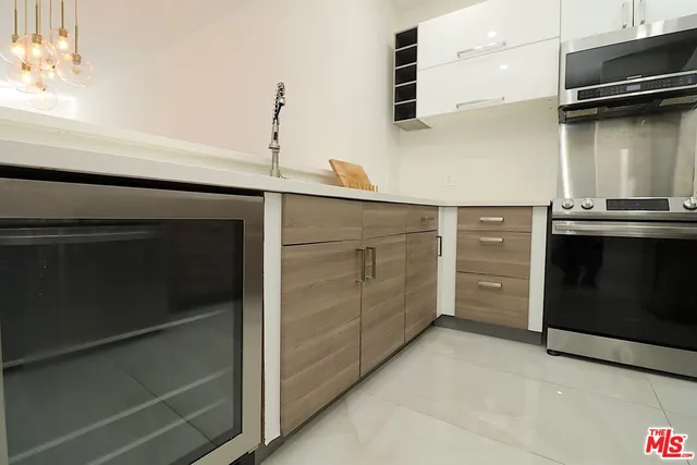 a kitchen with white cabinets and appliances
