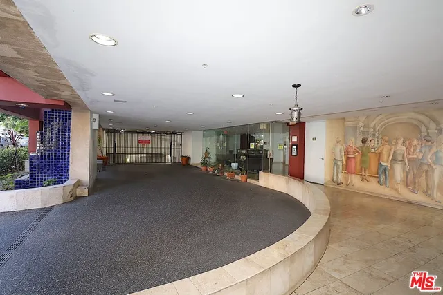 a view of a hallway with a table and chairs