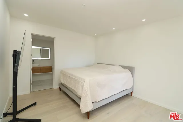 a large white bed in a white room