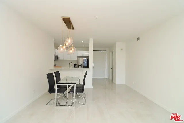 a dining room with furniture and chandelier