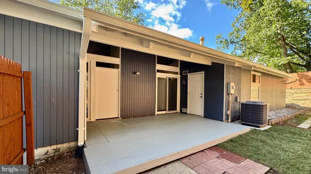 a view of an house with backyard and balcony