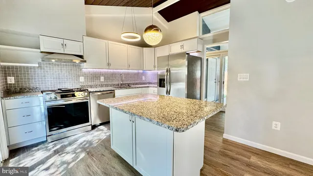 a kitchen with cabinets and stainless steel appliances