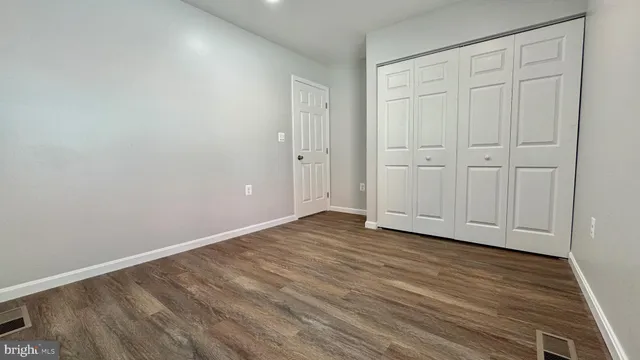 a view of an empty room and wooden floor