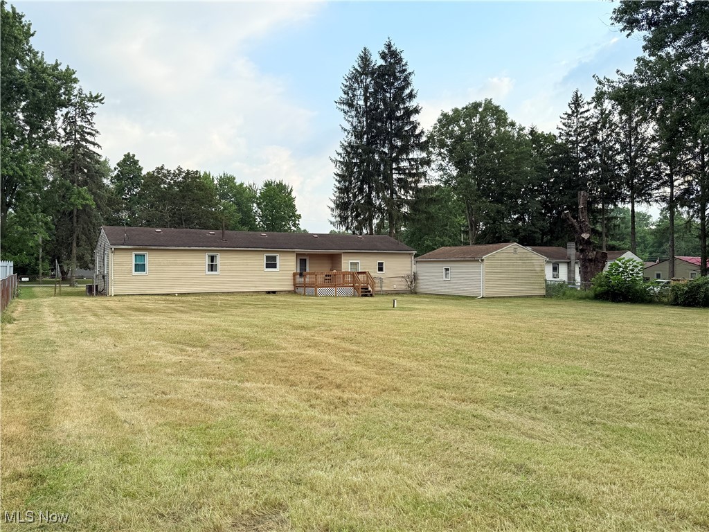 4185 Tapper Road Barberton, OH 44203 - Photo 20 of 23 Rear view of property with a wooden deck, crawl space, and a shed