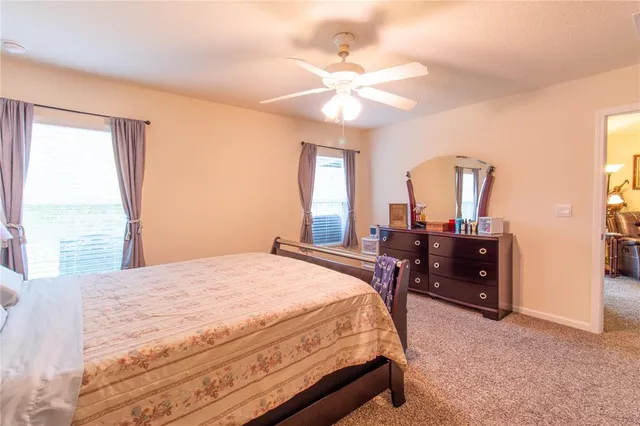 a view of a kitchen with refrigerator and white cabinets