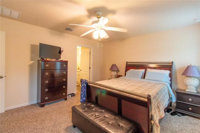 a bathroom with a toilet and a mirror