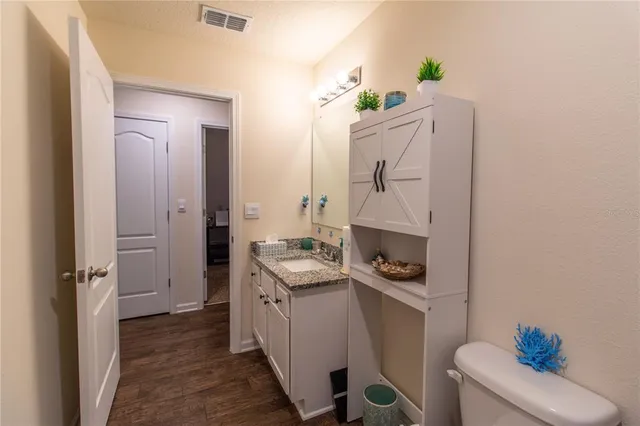 a living room with furniture a flat screen tv and a stove