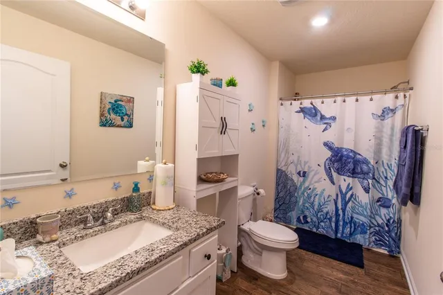 a work room with furniture and a wooden floor
