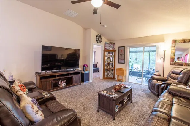 a kitchen with stainless steel appliances a refrigerator a stove top oven a sink dishwasher and white cabinets with wooden floor