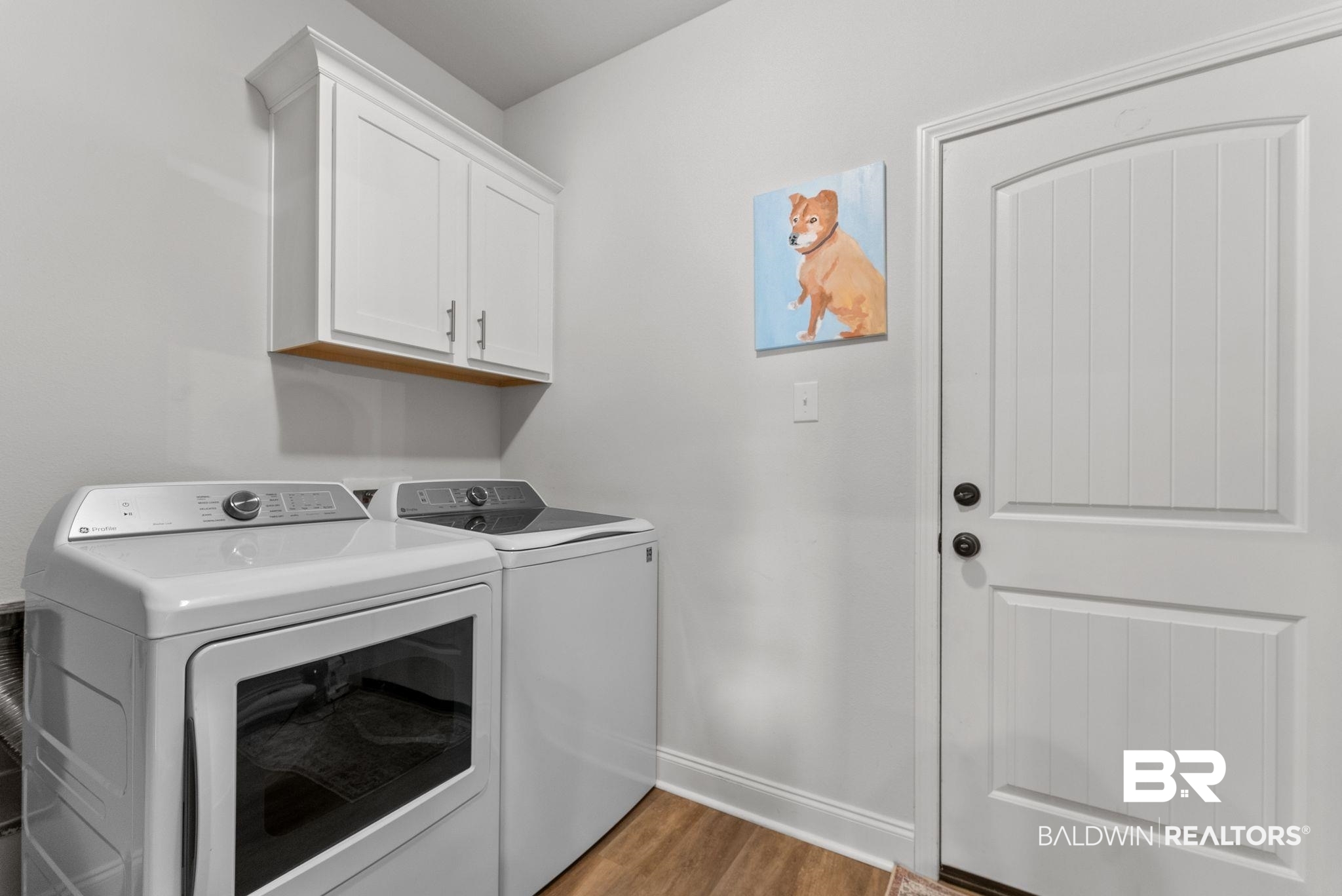 10745 Brodick Loop Daphne, AL 36527 - Photo 23 of 39 Laundry room featuring light wood finished floors, cabinet space, and washing machine and clothes dryer