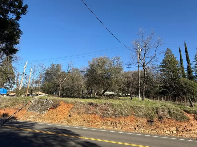 a view of a yard with wooden fence
