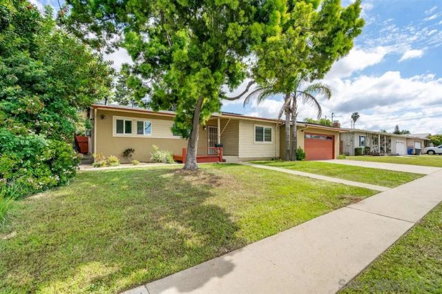 a front view of house with yard and green space