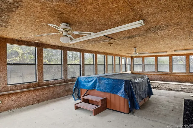 a bed sitting in a room next to a large window
