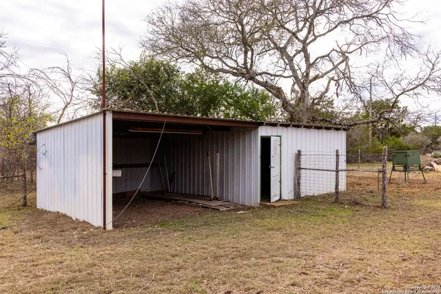 a view of house with backyard and trees