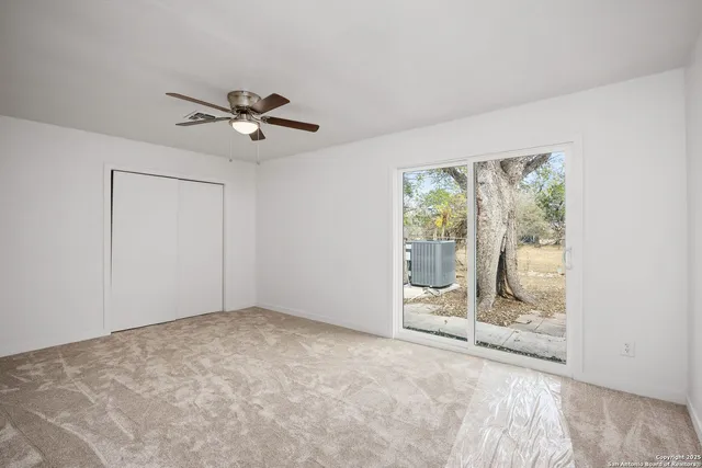 a view of room with window and ceiling fan